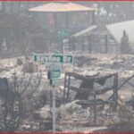 Charred ruins of a residential area after a fire, with a green street sign reading 'Limestone Dr' in the foreground.
