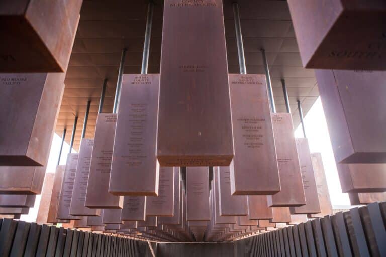 Rows of suspended steel monuments at the National Memorial for Peace and Justice in Montgomery, Alabama.