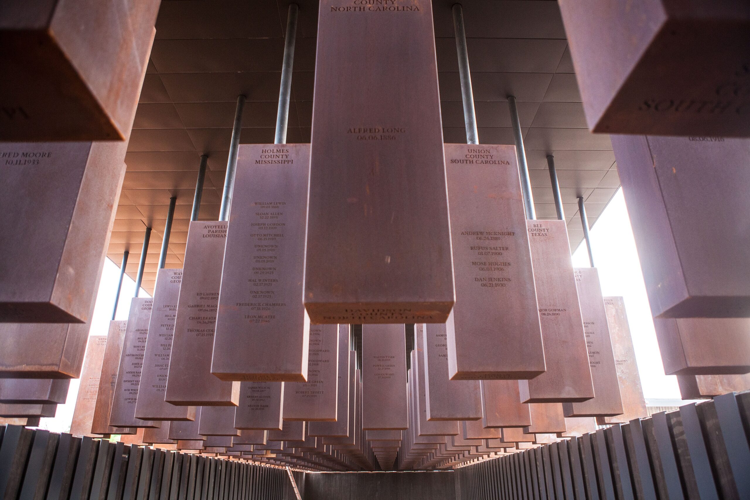 Rows of suspended steel monuments at the National Memorial for Peace and Justice in Montgomery, Alabama.