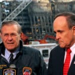 Rudy Giuliani and Donald Rumsfeld address reporters amid the wreckage at Ground Zero.