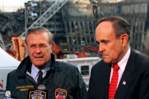 Rudy Giuliani and Donald Rumsfeld address reporters amid the wreckage at Ground Zero.