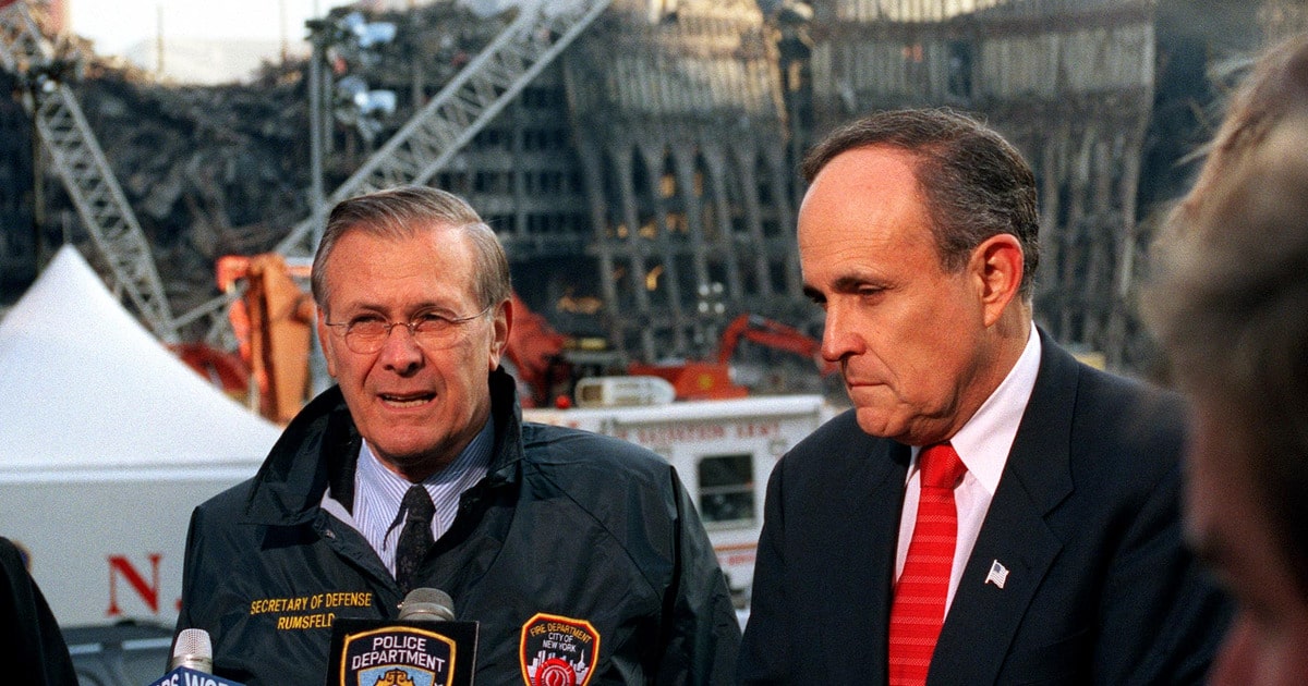 Rudy Giuliani and Donald Rumsfeld address reporters amid the wreckage at Ground Zero.