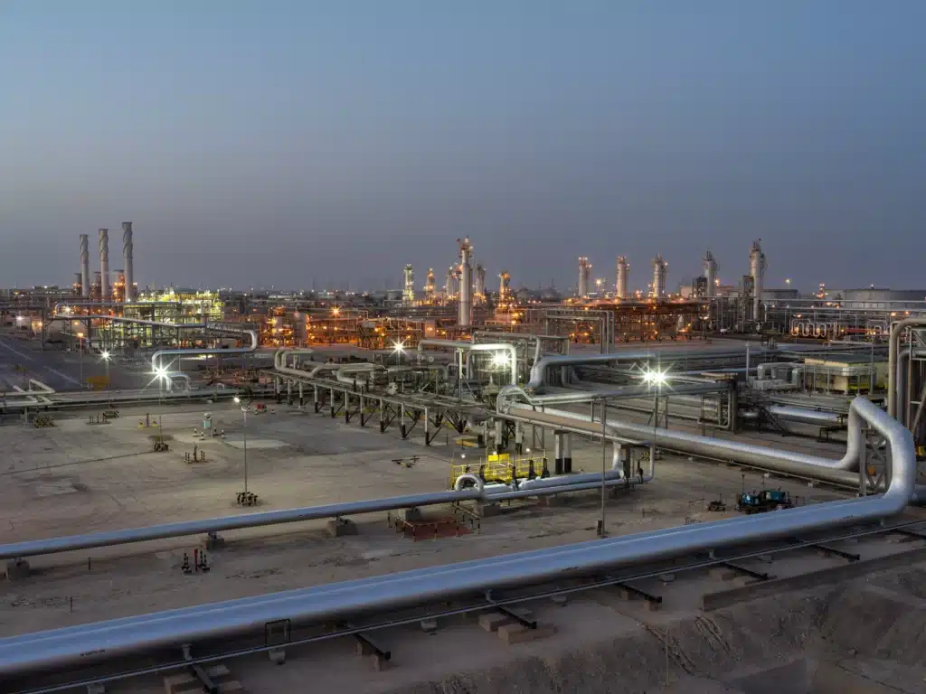 Pipes and processing equipment at Aramco’s Abqaiq complex at dusk.