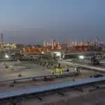 Pipes and processing equipment at Aramco’s Abqaiq complex at dusk.