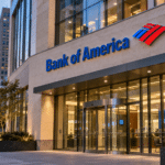 Editorial illustration of Bank of America signage above a modern banking center entrance at dusk.