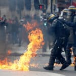 French CRS riot police protect themselves from flames during clashes at the traditional May Day labour union march in Paris