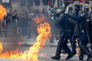 French CRS riot police protect themselves from flames during clashes at the traditional May Day labour union march in Paris