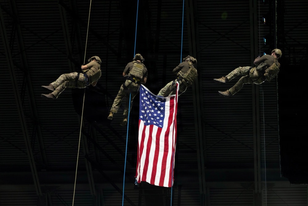 Military spectacle at the Alamodome, with soldiers rappelling beside an American flag during a previous pregame ceremony.