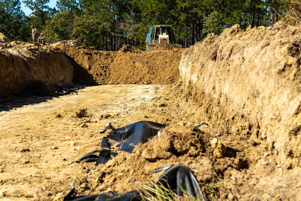 Army bulldozer backfills a simulated trench during mass graves training at Fort Bragg, North Carolina.