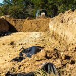 Army bulldozer backfills a simulated trench during mass graves training at Fort Bragg, North Carolina.