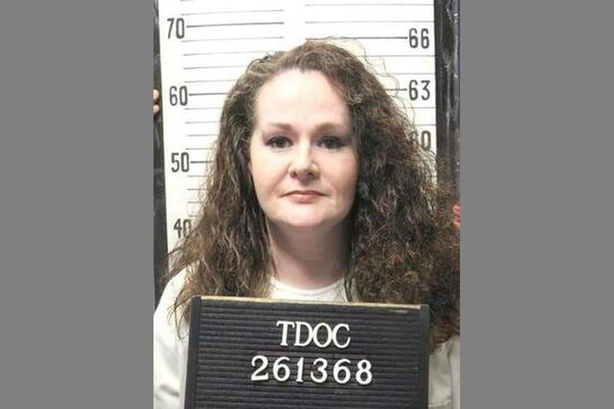 Christa Pike holding a Tennessee Department of Correction identification board.